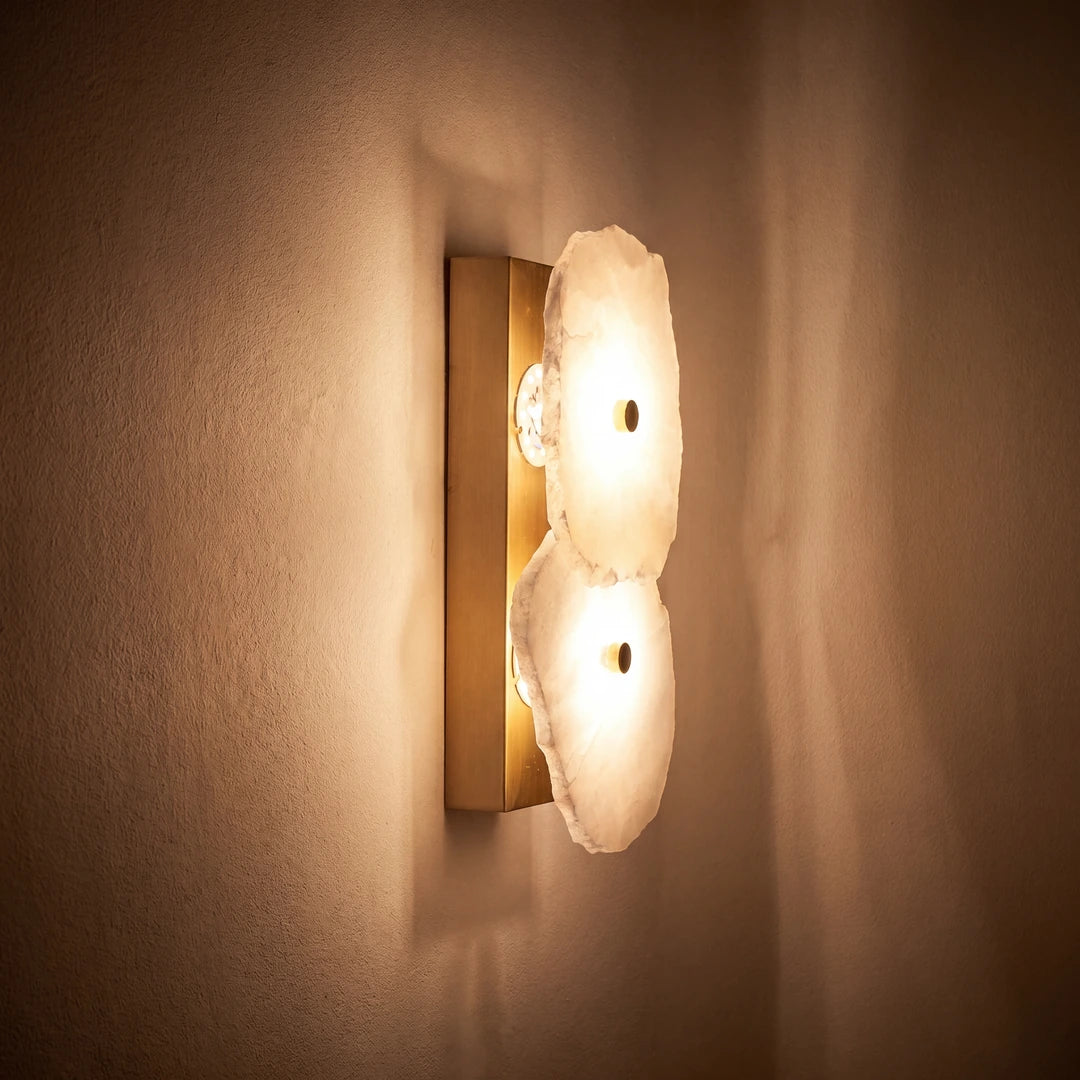 Wall-mounted light fixture with a warm glow on a beige wall.